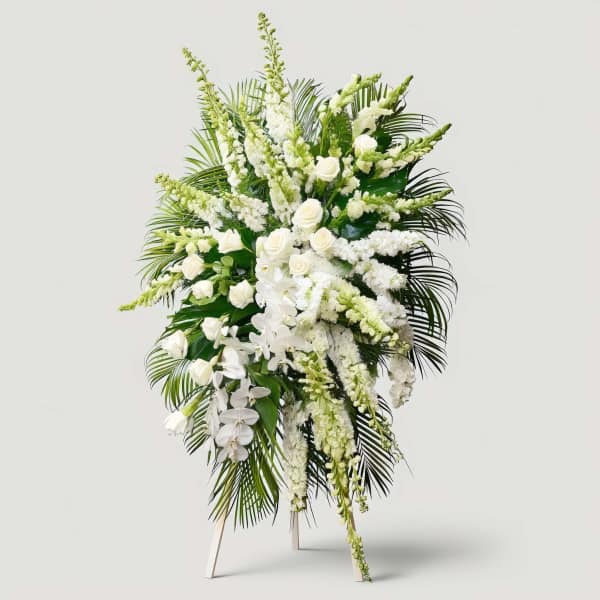 Tall white floral standing spray with roses and orchids