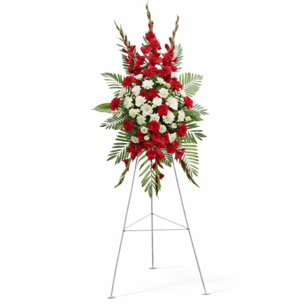 Standing floral spray of red and white flowers on an easel
