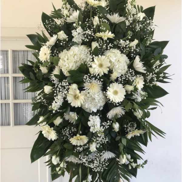 Large white funeral spray with daisies and roses