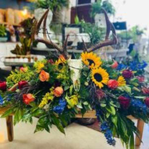 Large floral casket spray with sunflowers and mixed blooms