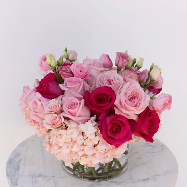 Pink and magenta rose bouquet in a clear glass vase