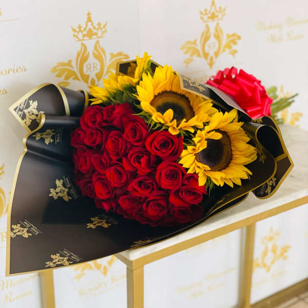 Bouquet of red roses and yellow sunflowers wrapped in black paper