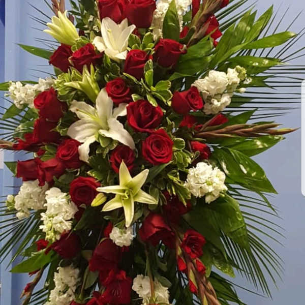 Tall red and white floral spray with palm fronds