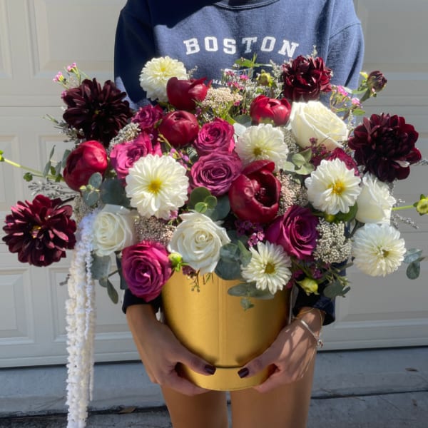 Large bouquet of roses and white dahlias in a gold box