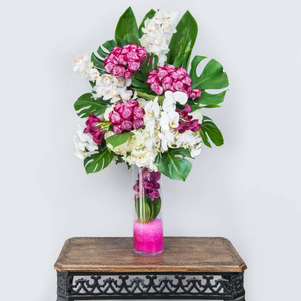 Tall vase arrangement with pink roses and white orchids