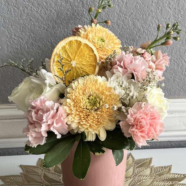 Pink and white bouquet with yellow chrysanthemums in a pink vase