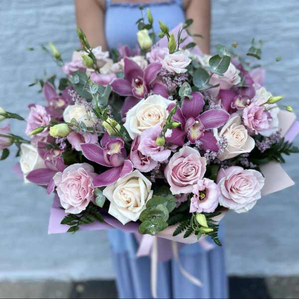 Bouquet of pink and white roses with purple orchids