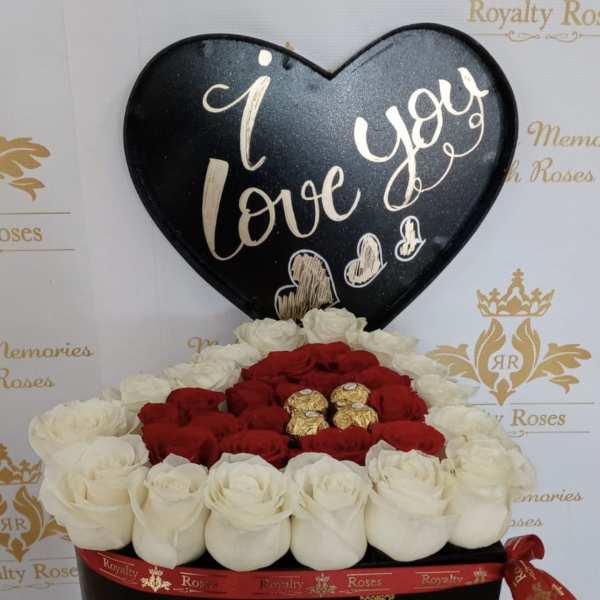 Heart-shaped box of red and white roses with chocolates and a love sign