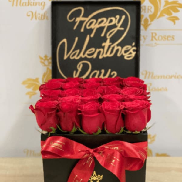 Red roses in a black gift box with a red ribbon and "Happy Valentine's Day" sign