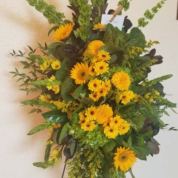 Tall yellow floral standing spray on an easel