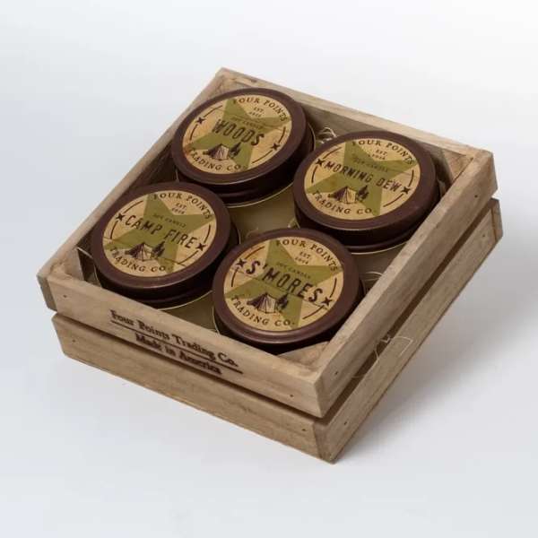 Wooden crate holding four round scented candles