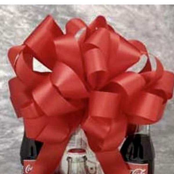 Gift basket with Coca-Cola bottles, candy bars, and a large red bow