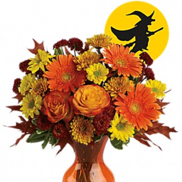 Orange and yellow mixed bouquet in an orange vase with a witch silhouette graphic behind it
