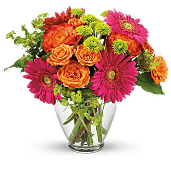 Bouquet of orange roses and pink gerbera daisies in a clear glass vase