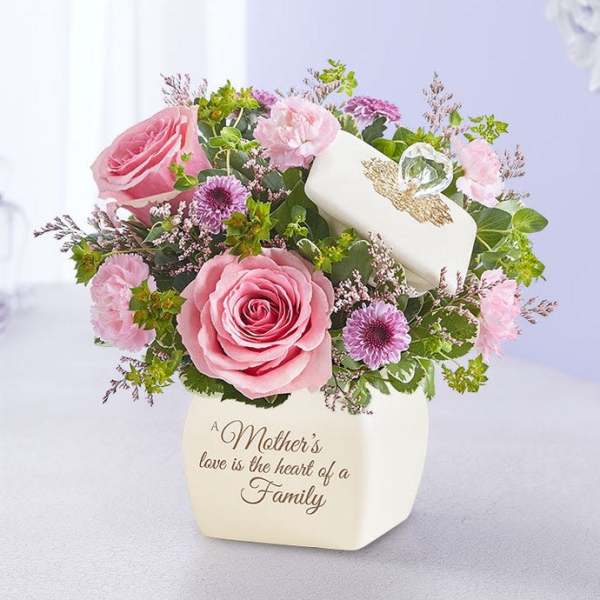 Pink roses and purple flowers in a white vase with a Mother's Day message