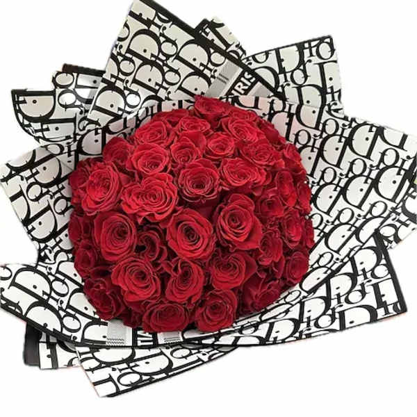 Bouquet of red roses wrapped in black-and-white patterned paper