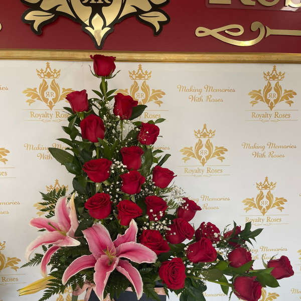 Tall arrangement of red roses and pink lilies in a black box
