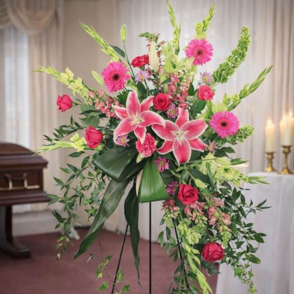 Tall standing floral spray with pink lilies, roses, and gerbera daisies