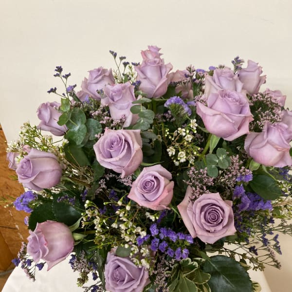 Bouquet of lavender roses with purple filler flowers