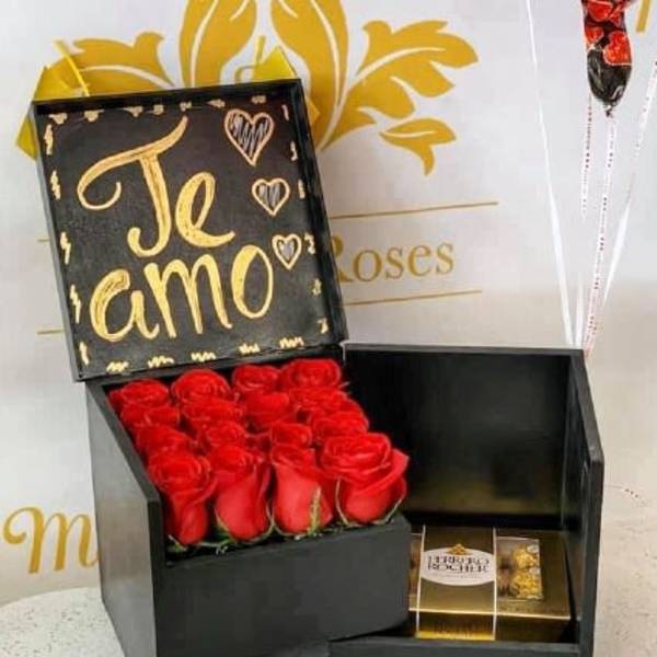 Black gift box with red roses and a chocolate box inside
