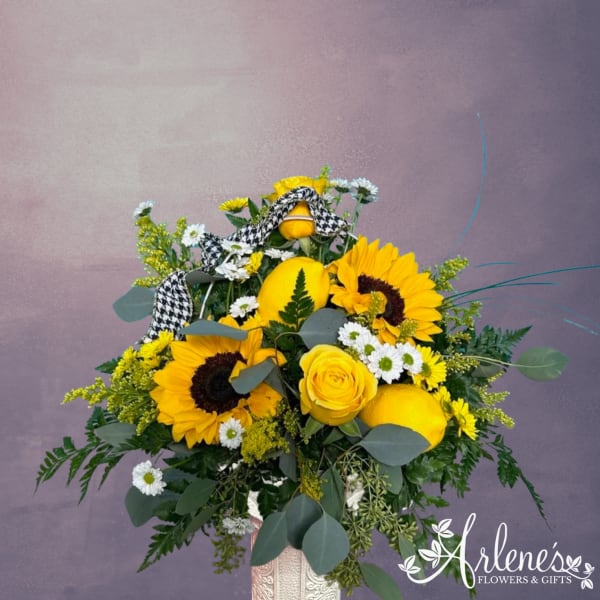 Yellow sunflower and rose bouquet with white daisies in a vase