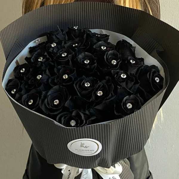 Bouquet of black roses with jeweled centers in dark wrapping
