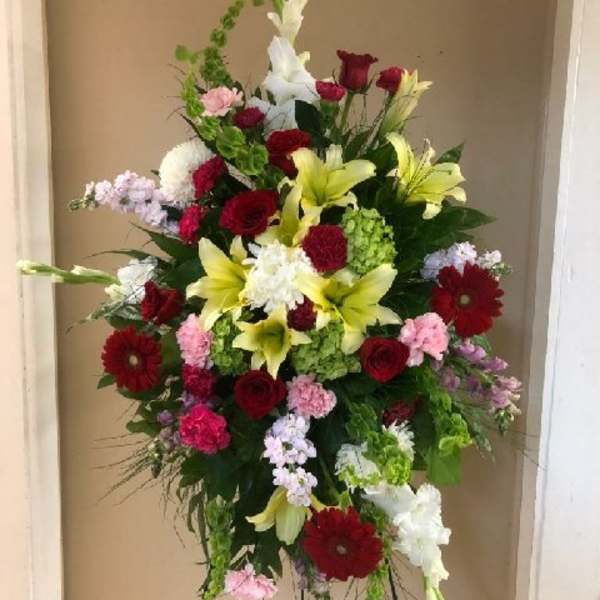 Tall mixed flower standing spray with red, white, pink, and yellow blooms