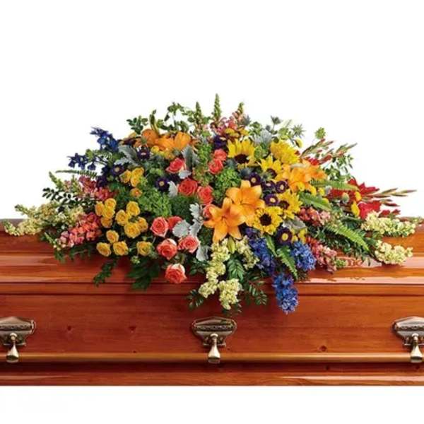 Colorful floral spray on a wooden casket