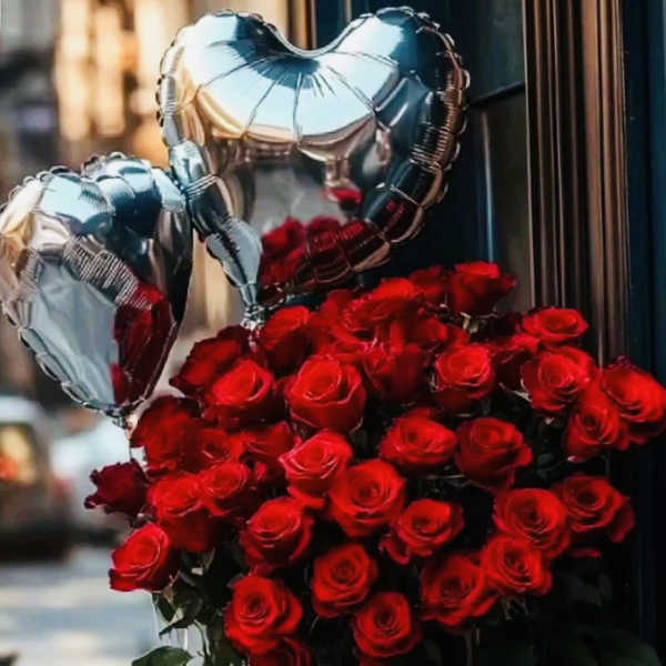 Red rose bouquet with silver heart balloons and a gift box