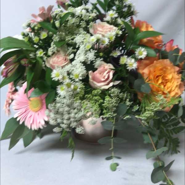 Mixed bouquet of pink and orange flowers in a vase
