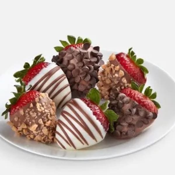 Plate of chocolate-covered strawberries with assorted toppings