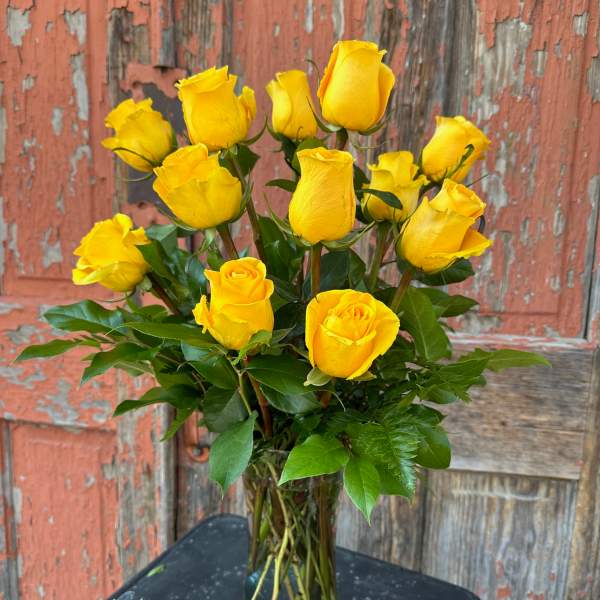 Yellow roses arranged in a clear glass vase