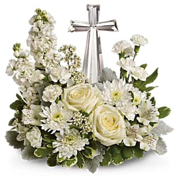 White floral arrangement with a silver cross centerpiece