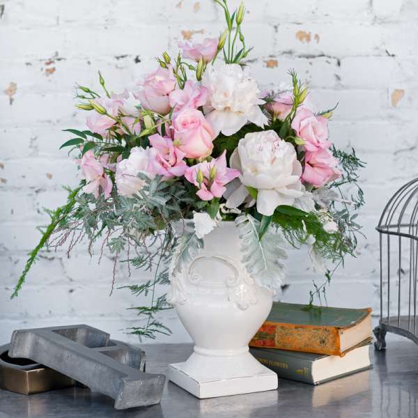 Pink and white floral arrangement in a white vase