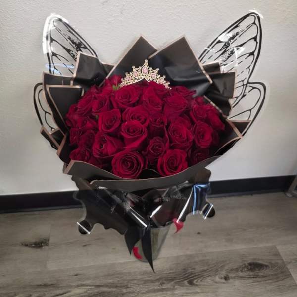 Bouquet of deep red roses wrapped in black paper with butterfly wings
