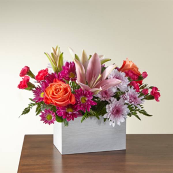 Mixed bouquet in a white square box with pink lilies and orange roses