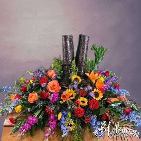 Colorful floral arrangement around a pair of black boots