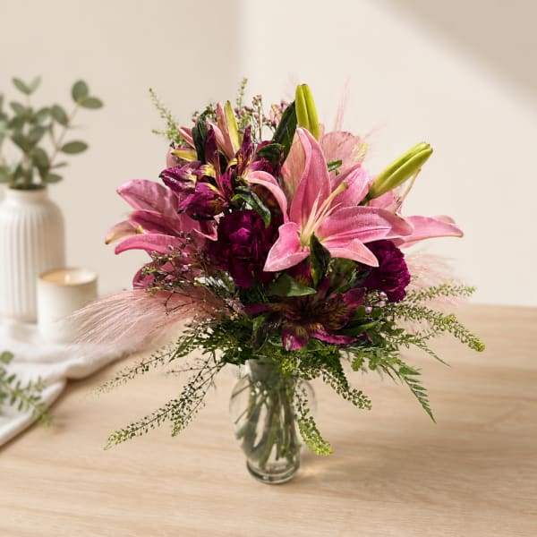 Pink and purple flower bouquet in a clear glass vase