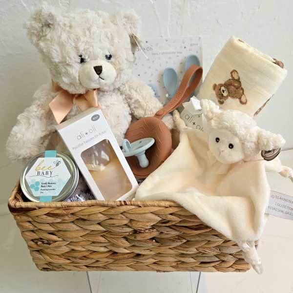 Baby gift basket with teddy bears, blanket, pacifier, and feeding items