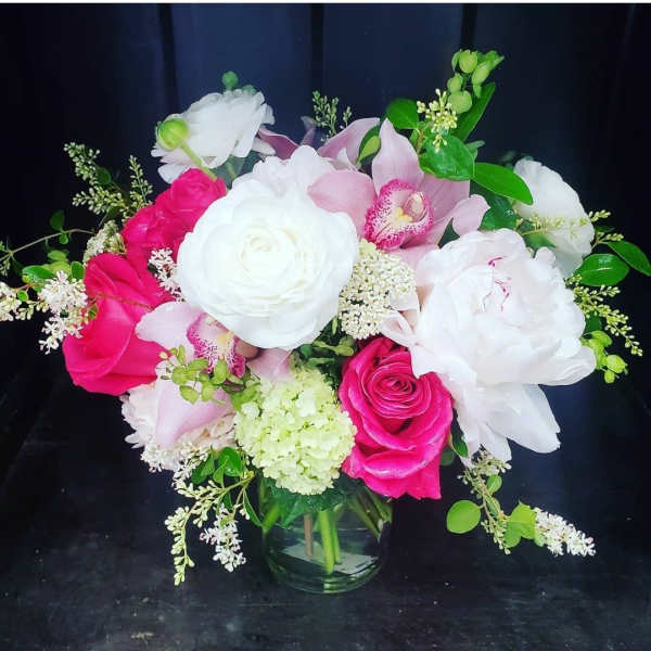 Pink and white floral bouquet in a glass vase