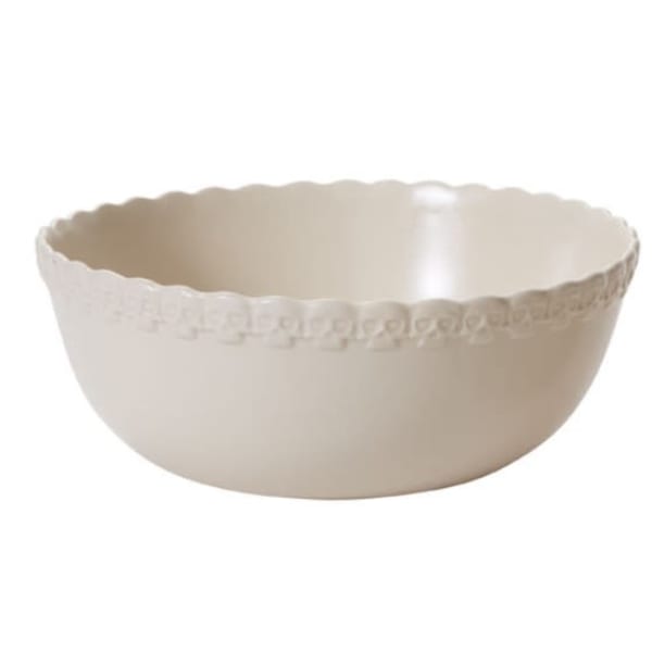 Cream-colored scalloped ceramic bowl with a decorative rim