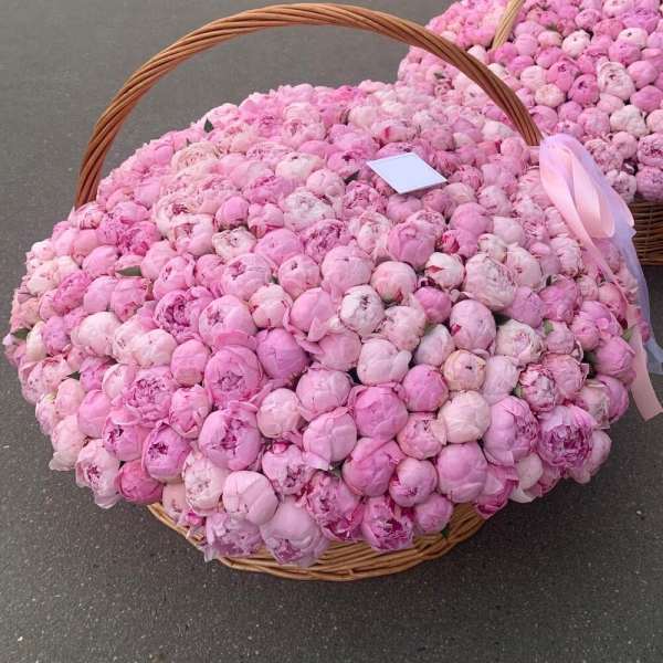Large basket filled with pink peonies