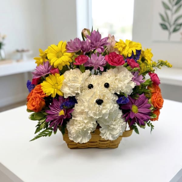 Basket arrangement with a white teddy bear made of flowers and colorful blooms