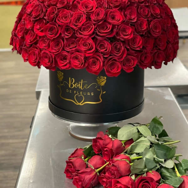 Large dome of red roses in a black round box