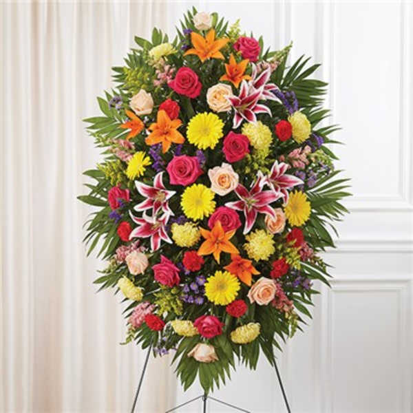 Standing funeral spray with mixed colorful flowers on an easel
