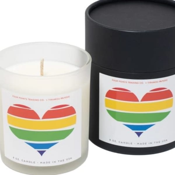 Two scented candles in frosted glass jars with rainbow heart labels