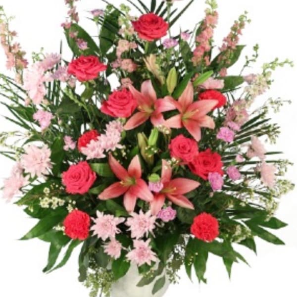 Pink roses and lilies in a tall mixed bouquet