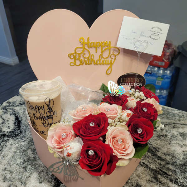 Heart-shaped birthday gift box with roses, chocolates, and a drink