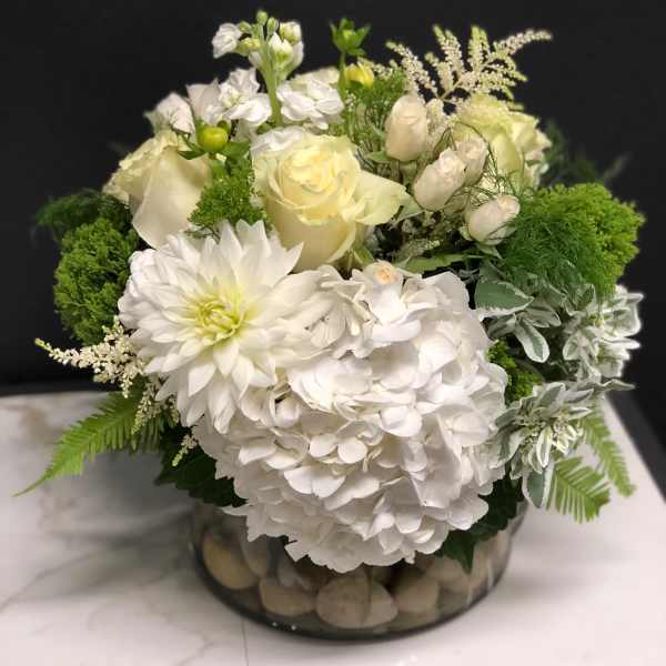 White floral arrangement in a low glass bowl
