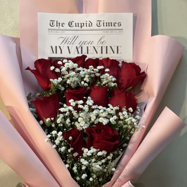 Bouquet of red roses with white baby's breath in pink wrapping